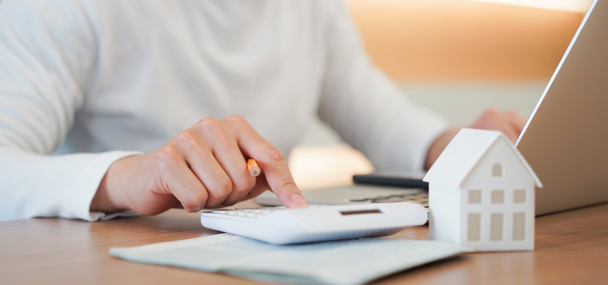 close up young man hand press on calculator to check and summary expense of home loan mortgage for refinance plan , people lifestyle concept close up young man hand press on calculator to check and summary expense of home loan mortgage for refinance plan , people lifestyle concept